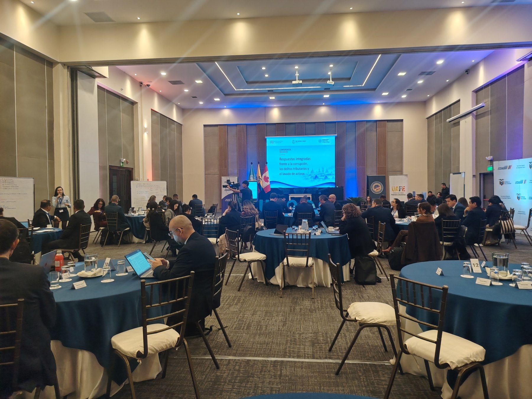 Encuentro internacional con escenario, pantalla y asistentes